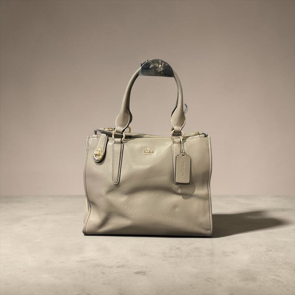 Coach Rowan satchel is crafted from smooth taupe leather